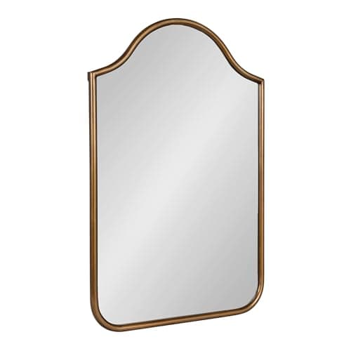 A round wall mirror in a styled entryway