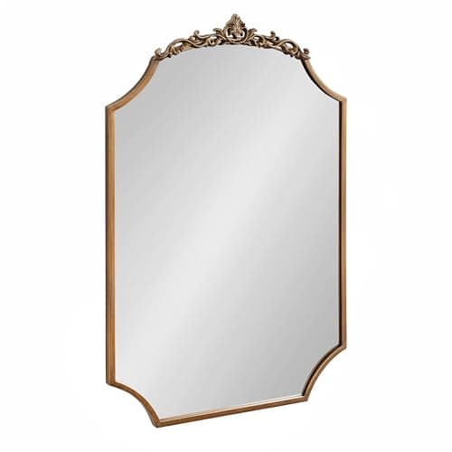 A round wall mirror in a styled entryway