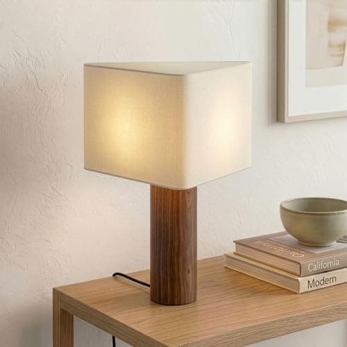 A table lamp casting warm light on a side table