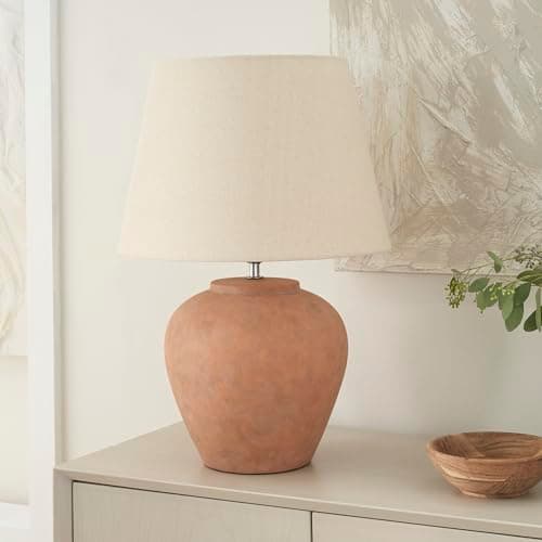A table lamp casting warm light on a side table