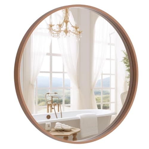 A round wall mirror in a styled entryway