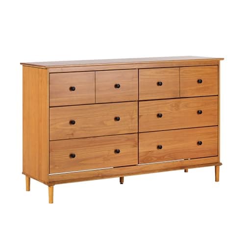 A wood dresser styled in a bedroom
