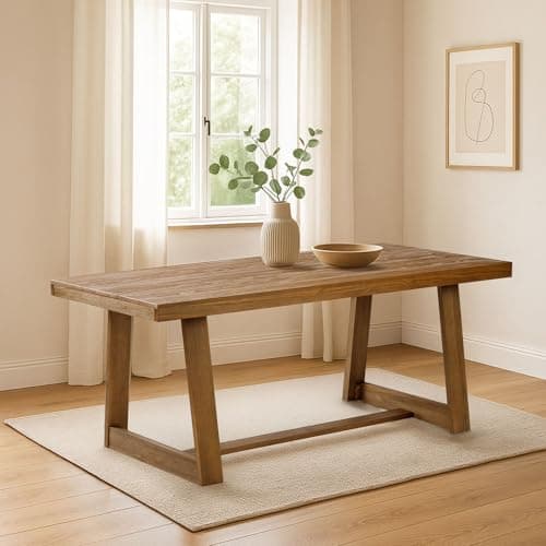 A dining table and chairs in a warm interior