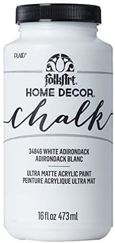 Painting a dresser with a brush during a DIY project