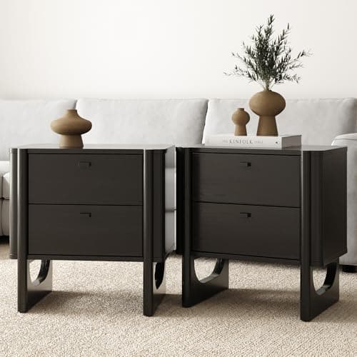 A nightstand with a bedside lamp and decor
