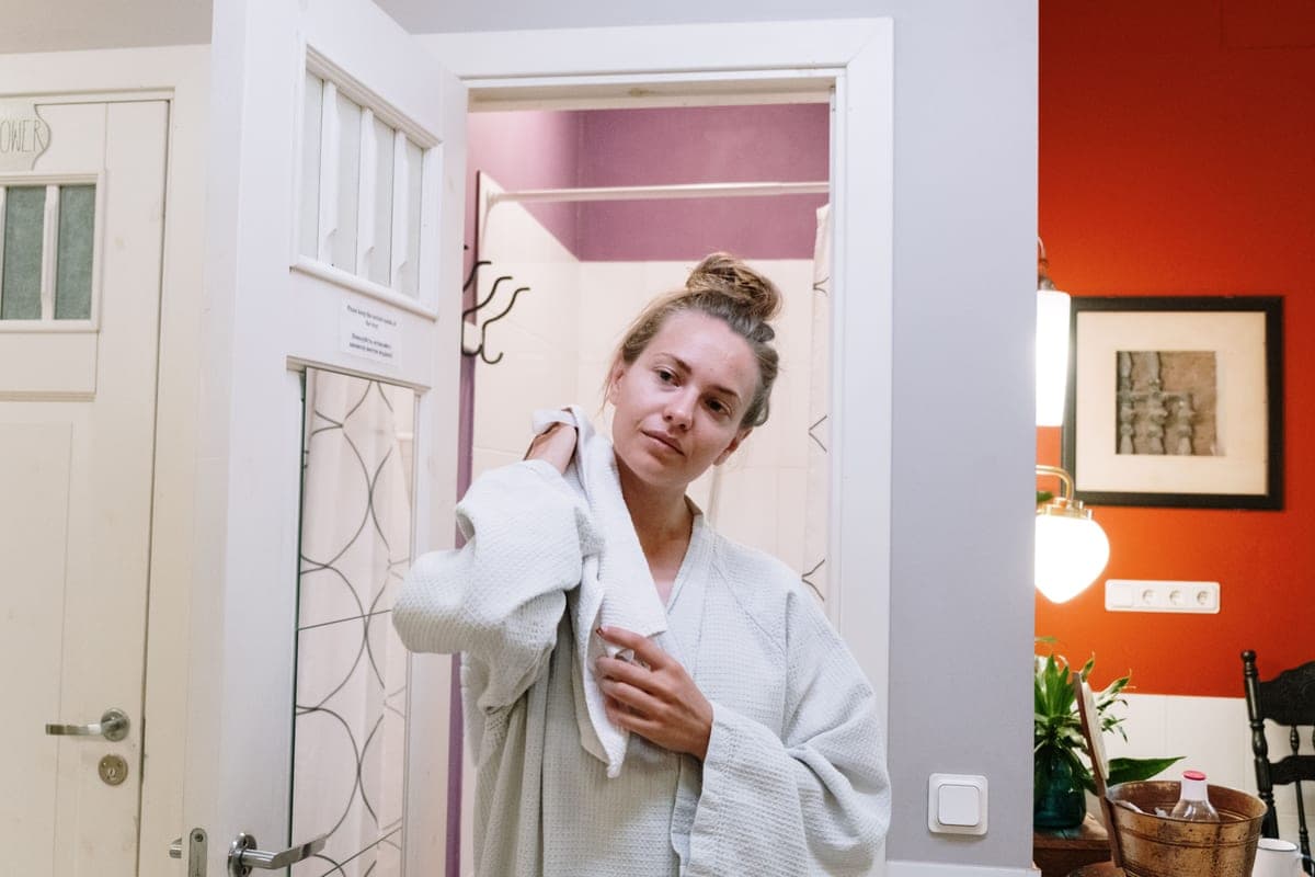 A warm bathroom styled with towels and plants