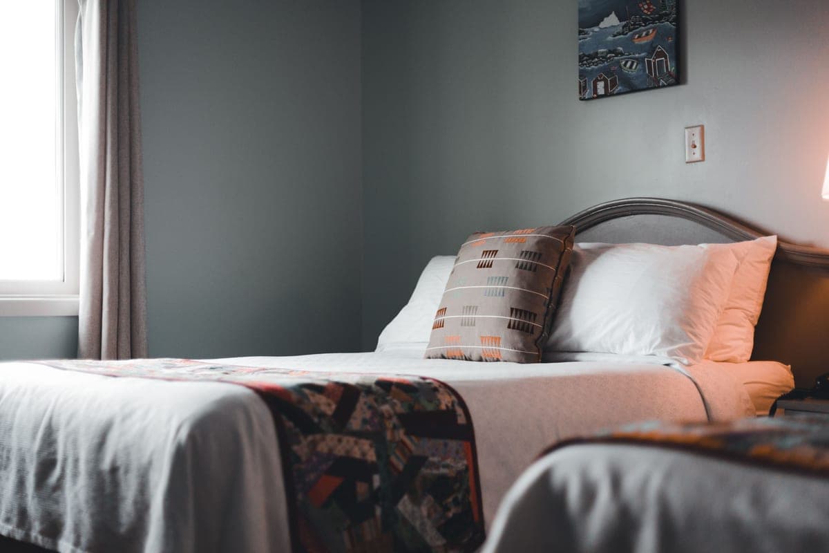 A made bed with layered linens in a cozy bedroom