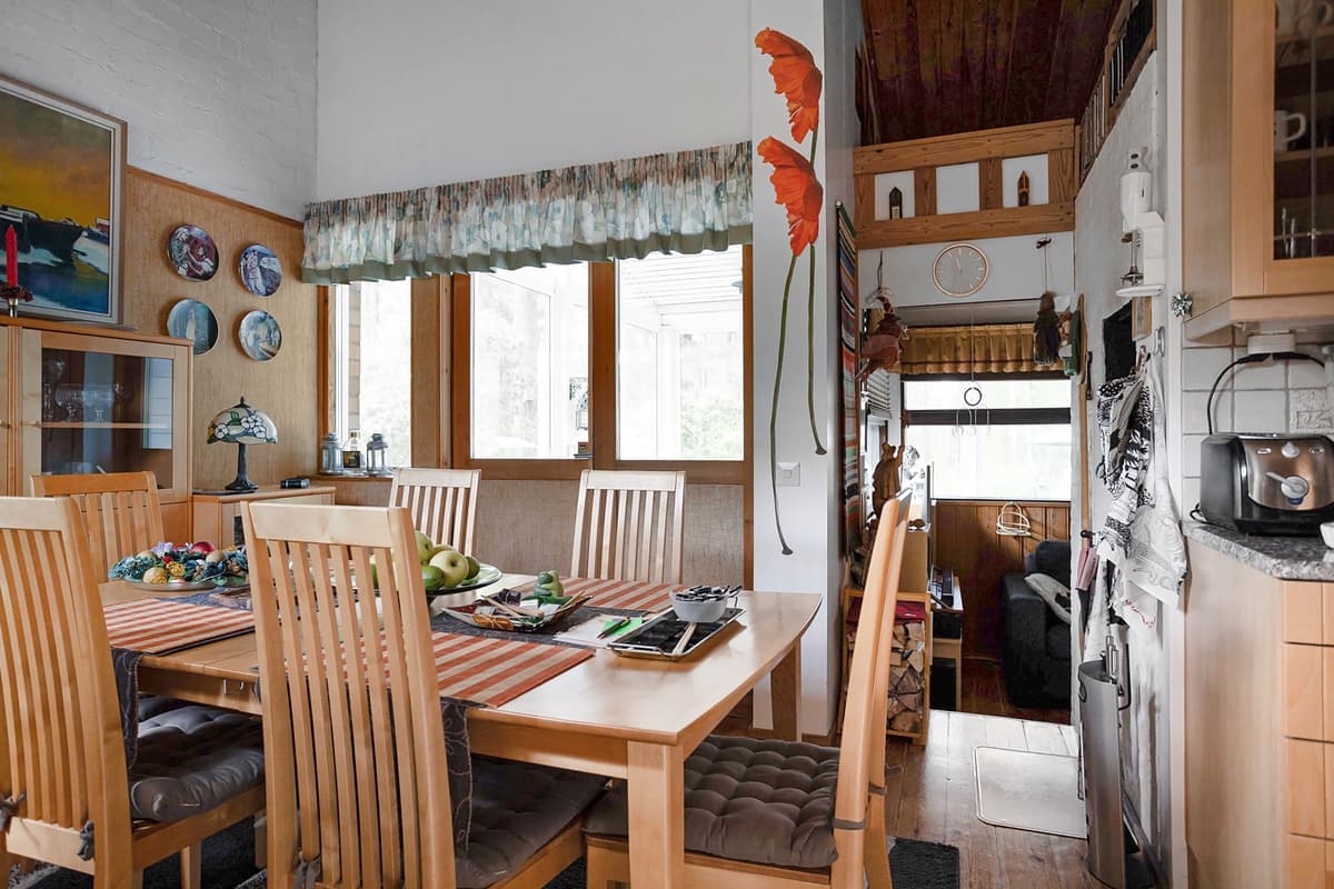 A dining table and chairs in a warm interior