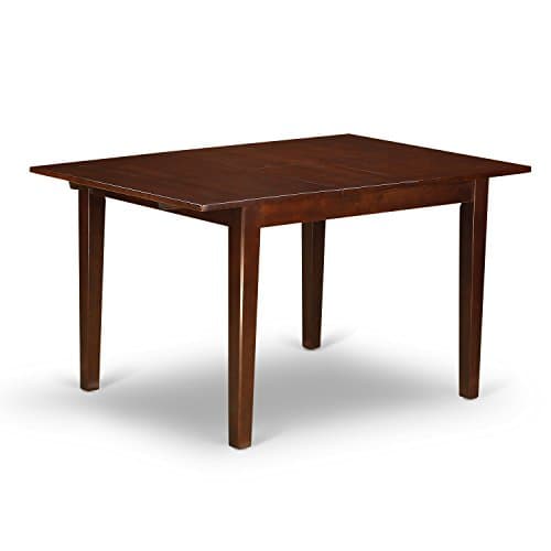 A dining table and chairs in a warm interior