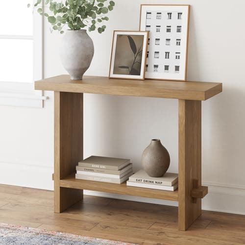 An entryway console table with decor and a mirror