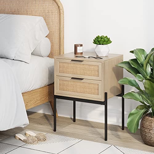 A nightstand with a bedside lamp and decor